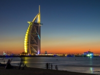 People waiting for new year celebration at the beach in last day of the year. The world\'s first seven stars luxury hotel Burj Al Arab and Dubai Marina in background,  johnkruger1